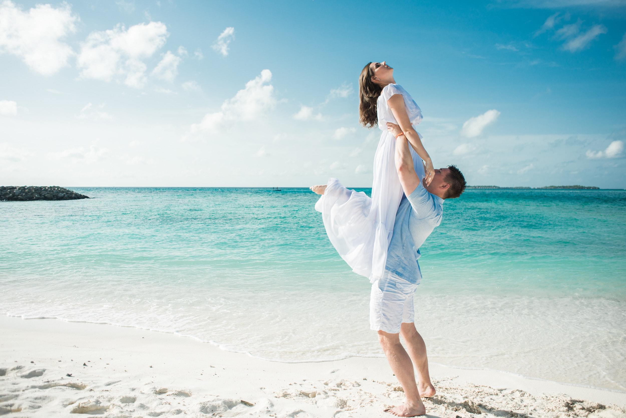 Man in blue shirt carrying woman in white dress 2549082